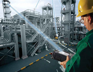 engineer outside a large industrial workplace