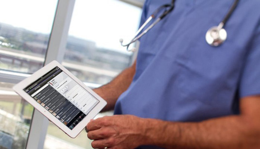 doctor analyzing patient records on a wireless mobile device