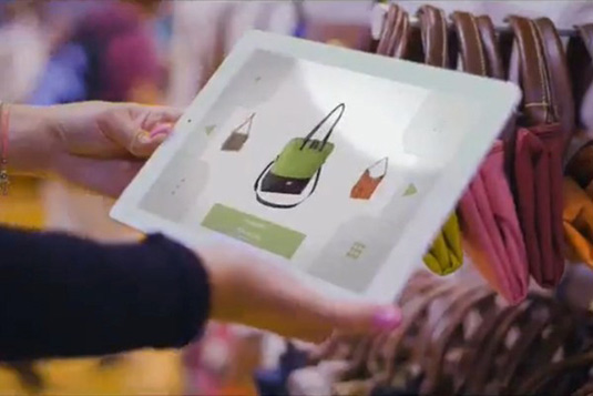 retail shopper in store holding a mobile tablet
